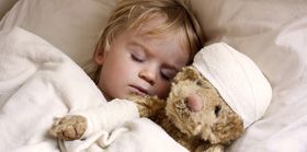 boy and teddybear in bed